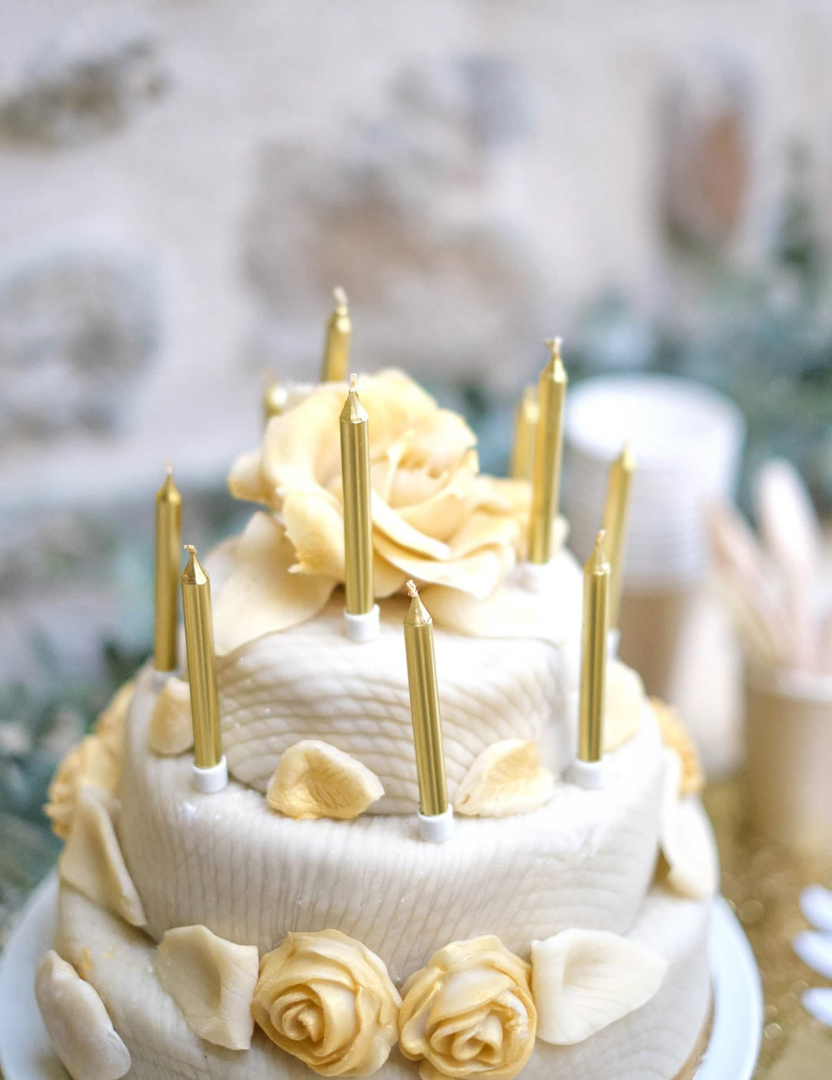 Escenificación sobre un pastel de velas de cumpleaños doradas metalizadas