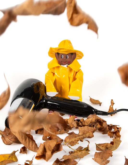 Mise en scène du déguisement imperméable de lutin farceur pour poupée avec sèche-cheveux et feuilles mortes
