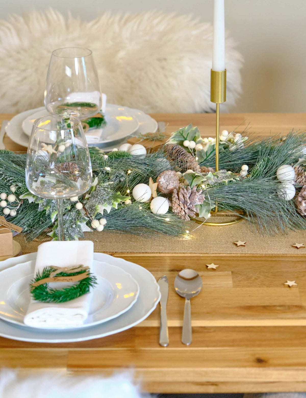 Mise en scène en centre de table de la guirlande de Noël feuillage vert et pommes de pin