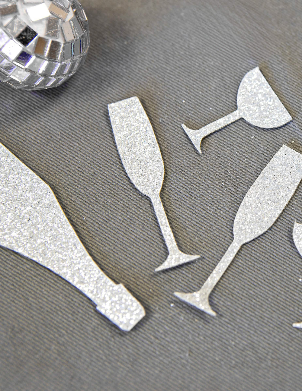 Primer plano de la textura brillante de los confetis de mesa champán plateados copas y flautas