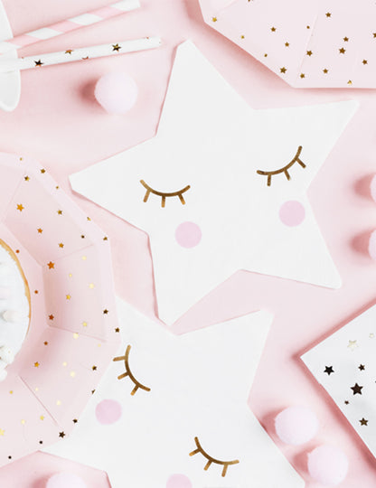 Détail du motif visage des serviettes en papier petite étoile blanche aux yeux dorés