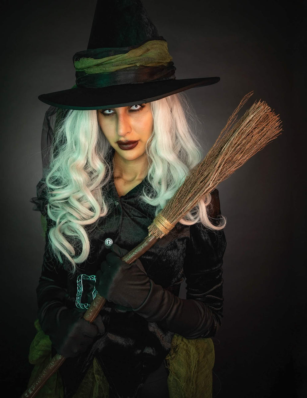 Mise en situation du balai de sorcière pour déguisement tenu par une sorcière