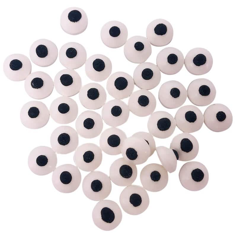 Gros plan de la décoration comestible petits yeux en sucre